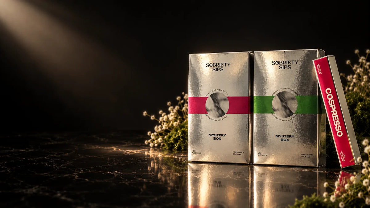 Two silver Sobriety Sips Mystery Boxes and a Cospresso tube